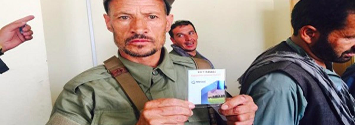 Afghanistan police holding up ID