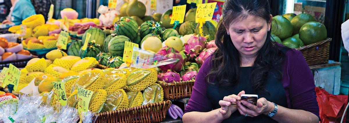 China Woman on the Phone in a Market