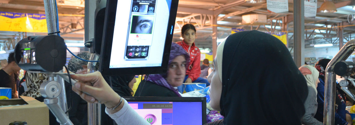 woman using technology to scan eye/facial recognition